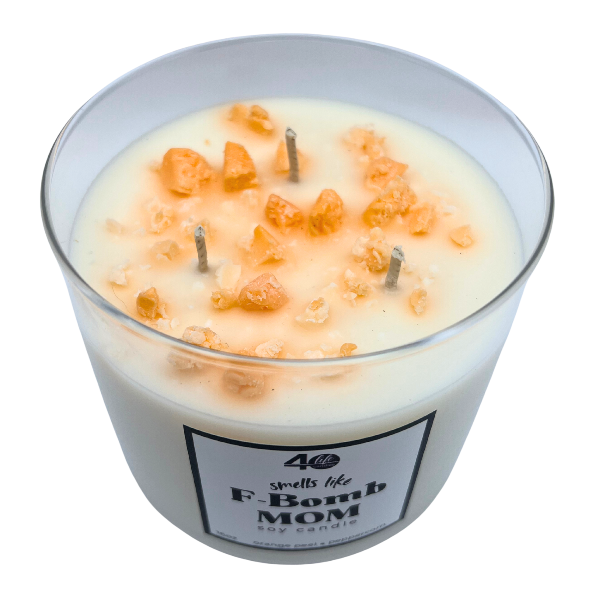 Candle in a glass jar labeled 'F-Bomb Mom' with decorative elements on a white background