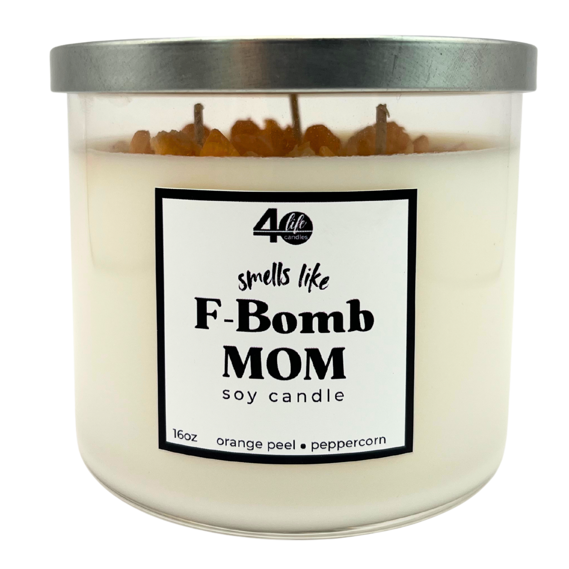 Candle with a label reading 'smells like F-Bomb Mom' on a white background