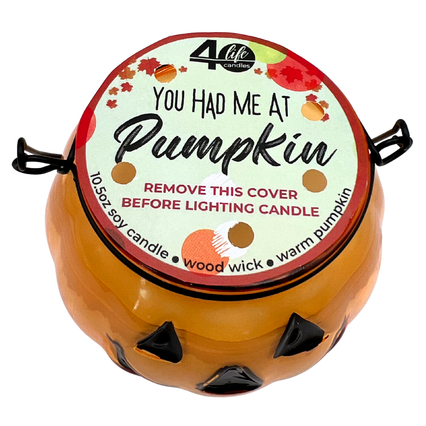 Pumpkin-shaped candle with a decorative label on a white background