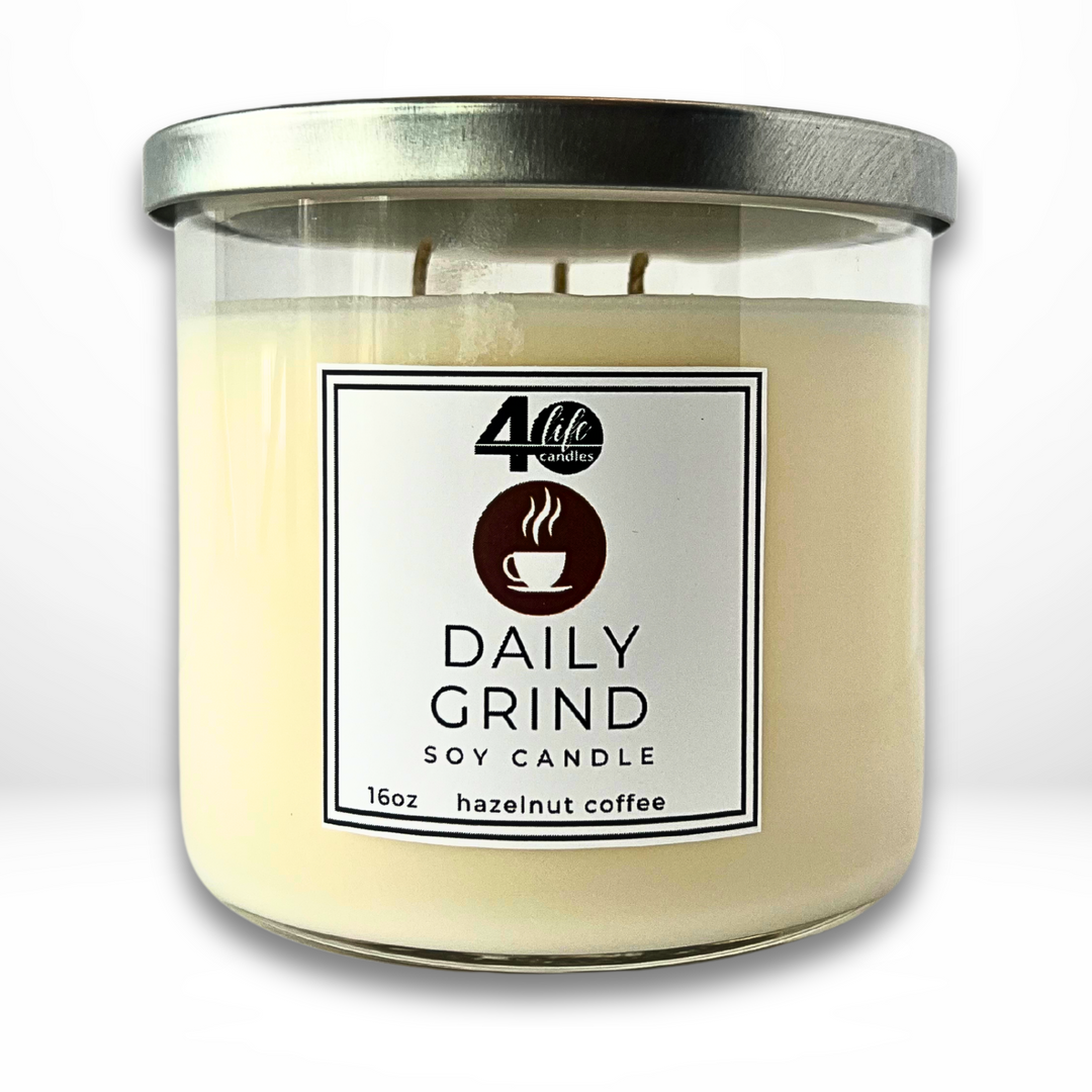 Daily Grind soy candle 16oz hazelnut coffee scent. 3 cotton wicks with a silver metal lid. White background.