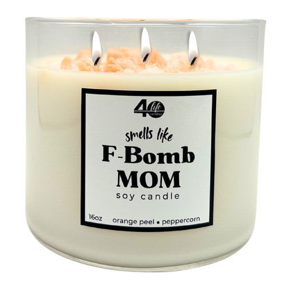 Soy candle labeled 'smells like F-Bomb Mom' with three wicks on a white background