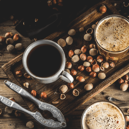 Hazelnuts and coffee on a wood table.