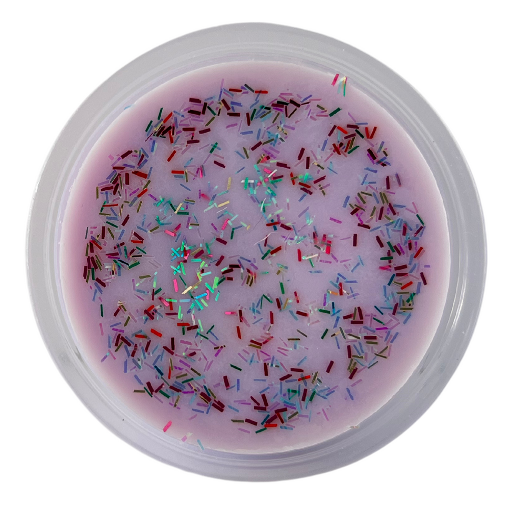 Purple scented soy wax melt in a 2oz shot cup with multi-color glitter on top. White background.