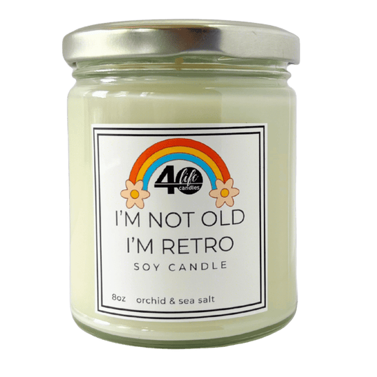 I'm not old I'm Retro soy candle jar with silver lid on a white background. Rainbow with flower on each side of it.
